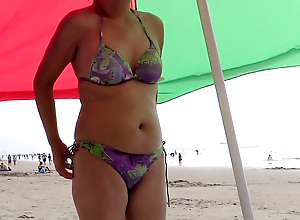 Latina mom shows off on the beach and masturbates deliciousl